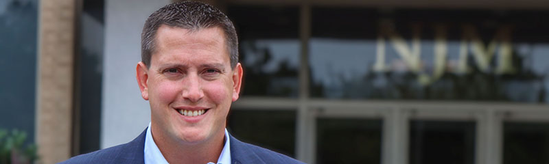 Headshot of NJM employee Carl in front of NJM office.