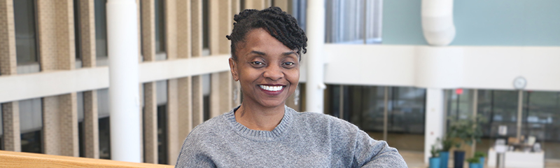 Headshot of NJM employee Mory posing in West Trenton atrium.