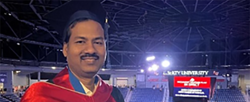 NJM employee at his graduation getting his MBA.