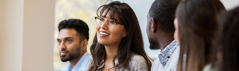 A cheerful young woman speaks during a design professionals training class.
